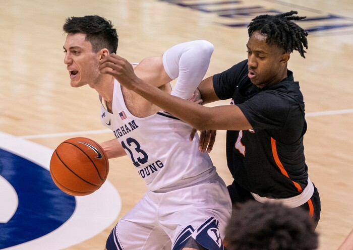 (Rick Egan | The Salt Lake Tribune) Brigham Young Cougars guard Brandon Averette (4) dribbles the ball up the middle, as Pacific Tigers guard Daniss Jenkins (4) defends, in basketball action at the Marriott Center in Provo, on Saturday, Jan. 30, 2021.