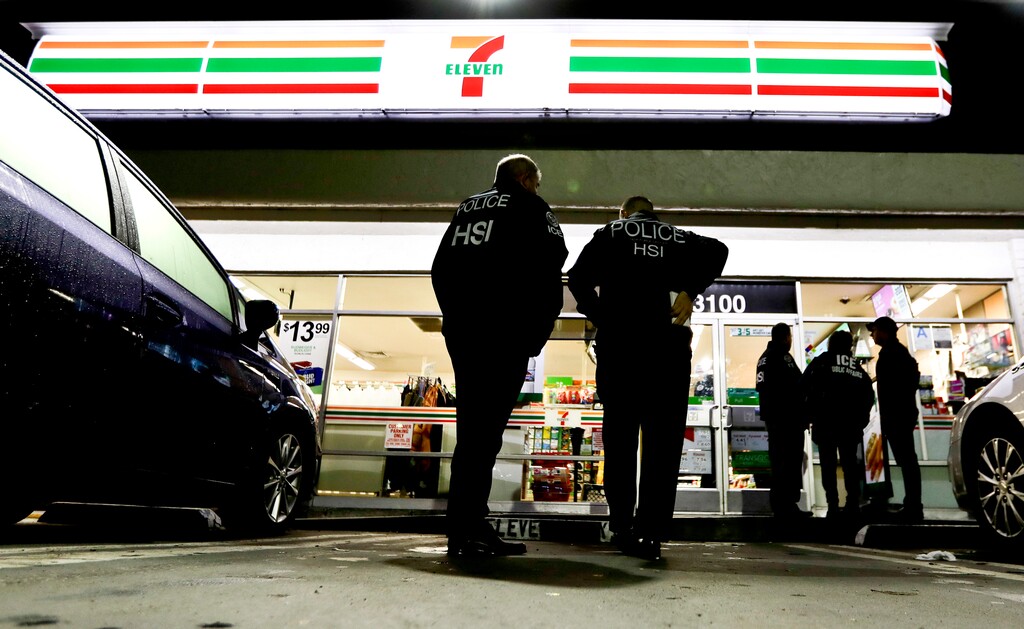 (Chris Carlson | The Associated Press) U.S. Immigration and Customs Enforcement agents serve an employment audit notice at a 7-Eleven convenience store Wednesday, Jan. 10, 2018, in Los Angeles. Agents said they targeted about 100 7-Eleven stores nationwide Wednesday to open employment audits and interview workers.