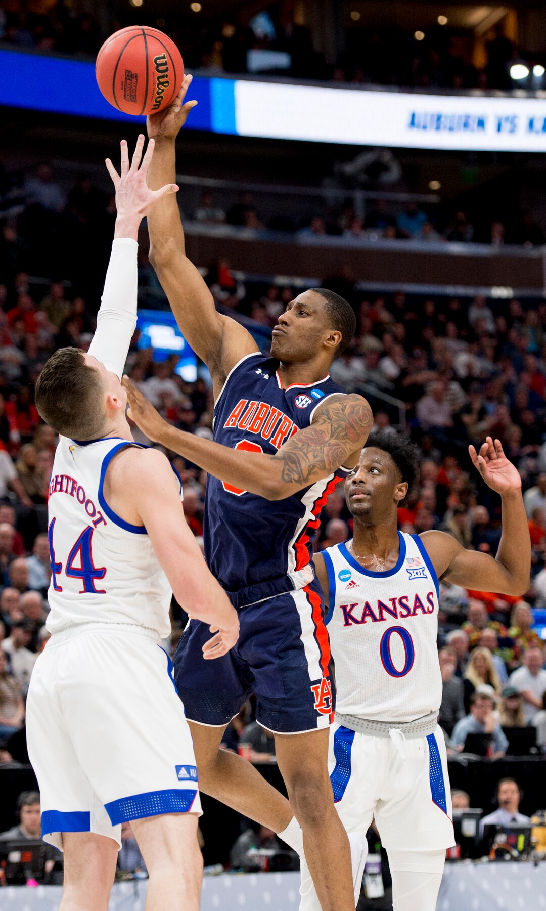 (Leah Hogsten  | The Salt Lake Tribune)  Auburn Tigers forward Horace Spencer (0) shoots over Kansas Jayhawks forward Mitch Lightfoot (44) as Auburn faces Kansas in the second round of the NCAA tournament in Salt Lake City on Saturday, March 23, 2019.