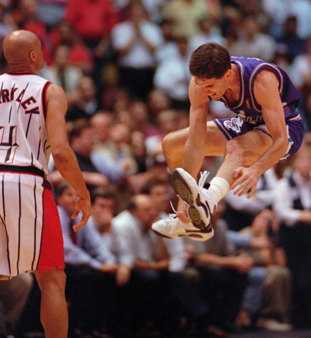 (Tim Johnson  |  Associated Press) Utah Jazz's John Stockton (12) leaps in the air after sinking a three-point shot a the buzzer to beat the Houston Rockets 103-100 Thursday, May 29, 1997, in Houston. The Rockets' Charles Barkley walks off the court at left. The Jazz advance to The NBA Finals to play the Chicago Bulls.