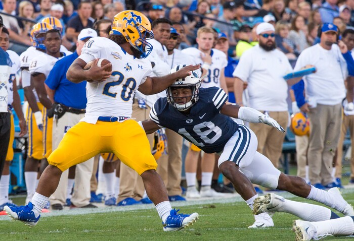 (Rick Egan  |  The Salt Lake Tribune)    Brigham Young Cougars defensive back Michael Shelton (18) brings down McNeese State Cowboys running back Justin Pratt (20), in football action Brigham Young Cougars vs McNeese State Cowboys at Lavell Edwards Stadium, Saturday, Sept. 22, 2018.


