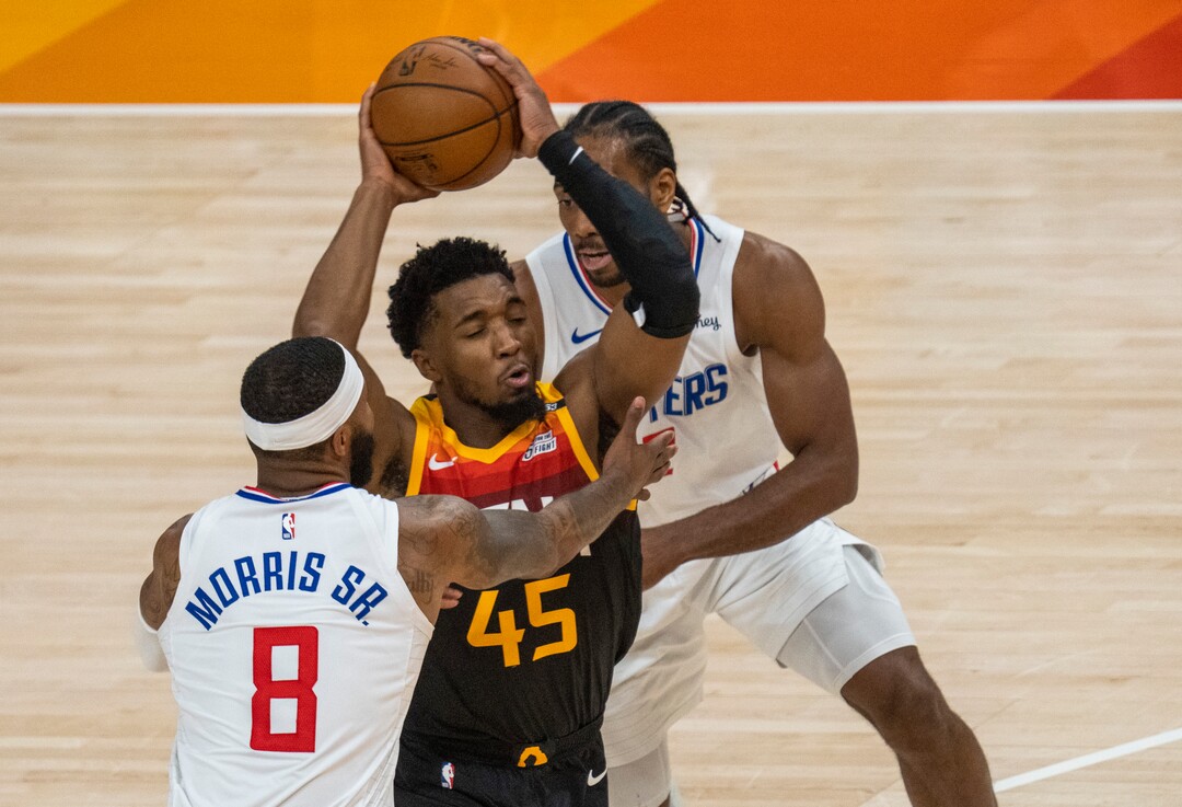(Rick Egan | The Salt Lake Tribune) Donovan Mitchell (45) splits the LA defenders, forward Kawhi Leonard (2)] and Clippers forward Marcus Morris Sr. (8) to score for the Jazz, in NBA action between the Utah Jazz and the LA Clippers, in game one in the second round of the NBA playoff series at Vivint Arena, on Tuesday, June 8, 2021.