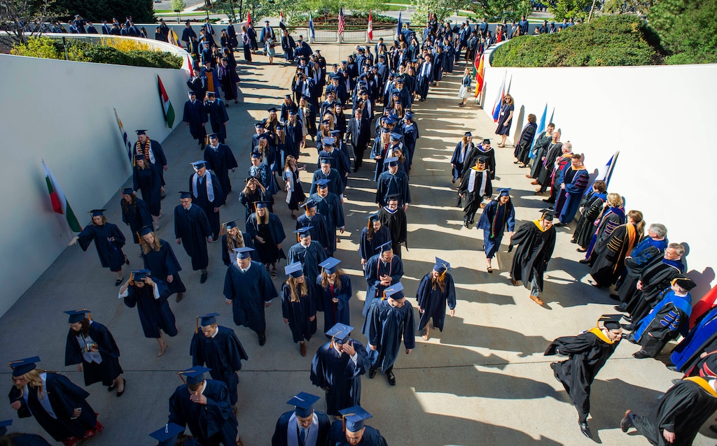 (Rick Egan  |  The Salt Lake Tribune)  Brigham Young University Graduates make their way to the Marriott Center for the 144th BYU Commencement, Thursday, April 25, 2019.