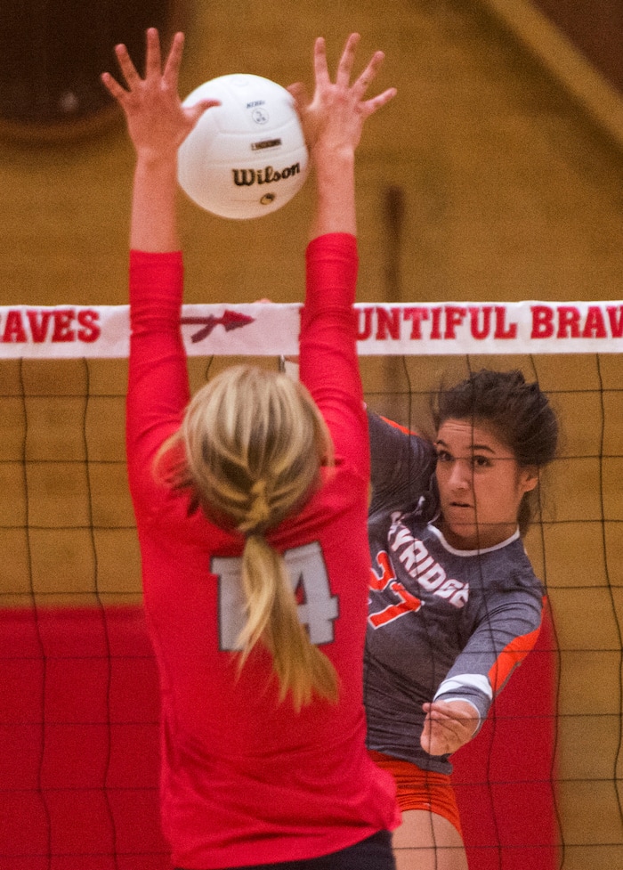 (Rick Egan  |  The Salt Lake Tribune)  Naomi Pulu (27), Skyridge, hits the ball past Bri Mortensen, 14, Bountiful, in volleyball action, Bountiful vs. Skyridge, at Bountiful High, Wednesday, September 6, 2017.