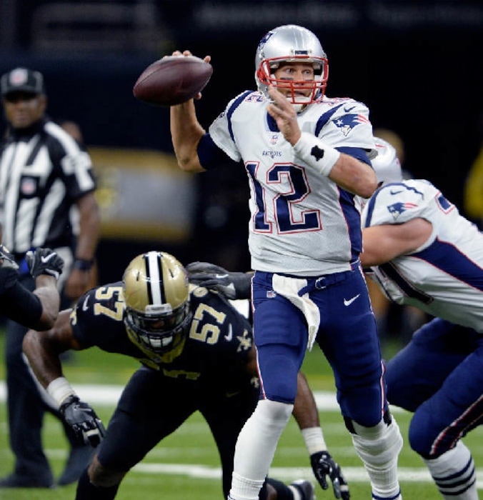Bill Feig | The Associated Press. New England Patriots quarterback Tom Brady (12) passes under pressure from New Orleans Saints defensive end Alex Okafor (57) in the first half of an NFL football game in New Orleans, Sunday, Sept. 17, 2017.
