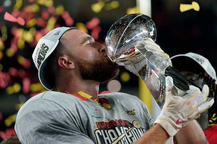 Kansas City Chiefs' Travis Kelce kisses the trophy after defeating the San Francisco 49ers in the NFL Super Bowl 54 football game Sunday, Feb. 2, 2020, in Miami Gardens, Fla. (AP Photo/David J. Phillip)