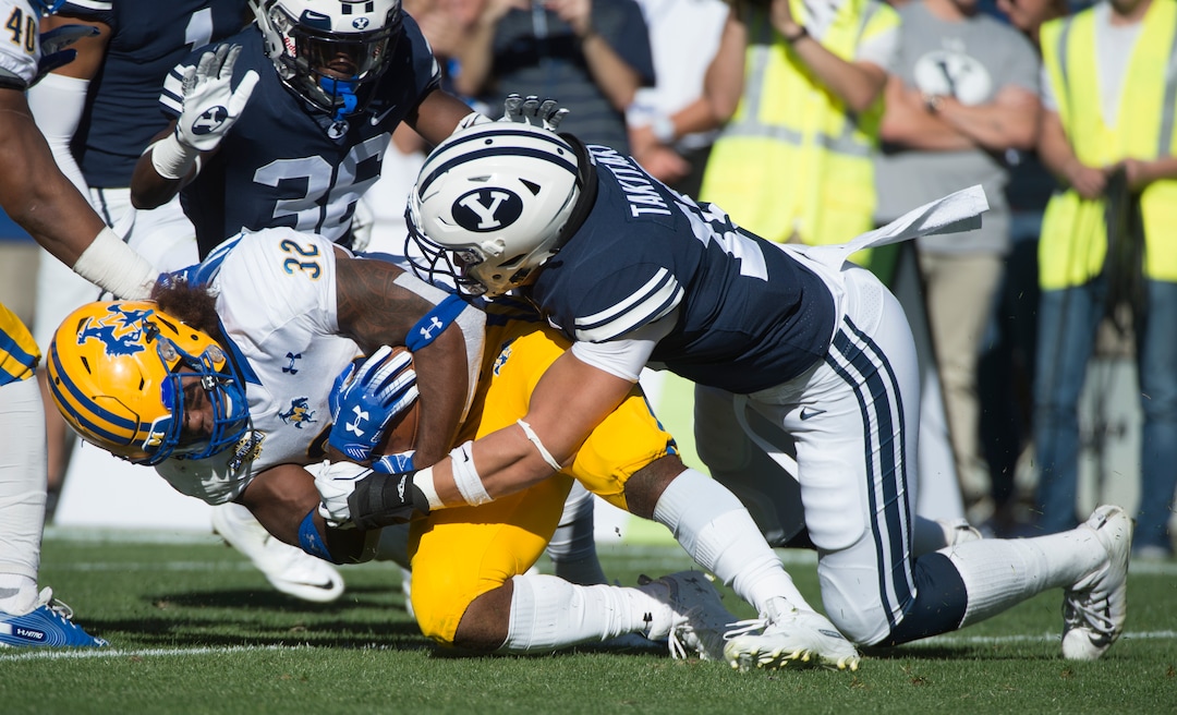 (Rick Egan  |  The Salt Lake Tribune)     Brigham Young Cougars linebacker Sione Takitaki (16) brings down McNeese State Cowboys running back David Hamm (32), in football action between Brigham Young Cougars and McNeese State Cowboys, at Lavell Edwards Stadium, Saturday, Sept. 22, 2018.