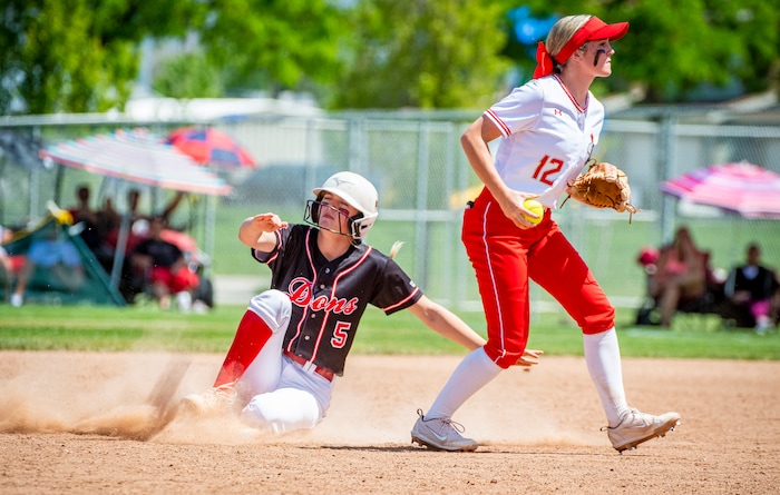 (Isaac Hale | Special to The Tribune) Spanish Fork pitcher Avery Sapp (5) slides into second base in vain after Mountain Ridge infielder Tessa Hokanson (12) beat her to the base with the ball during the second game of a best-of-three series between the Spanish Fork Lady Dons and the Mountain Ridge Sentinels as part of the 5A state softball championship held at the Spanish Fork Sports Park on Friday, May 28, 2021.