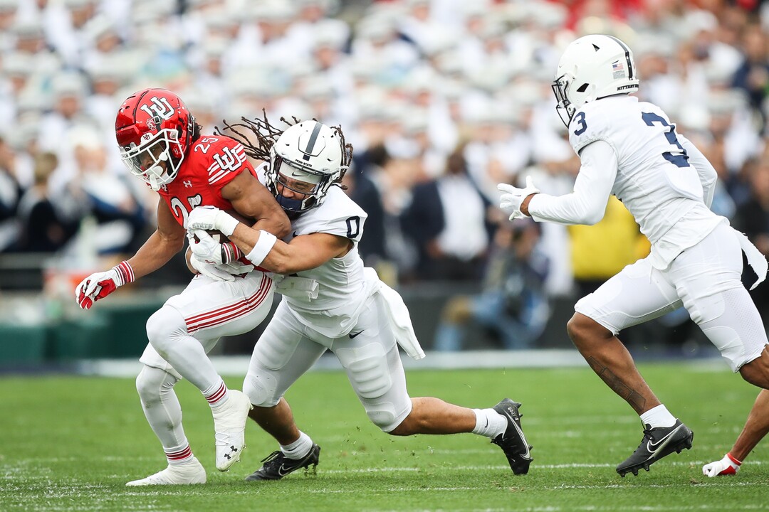 (Meg Oliphant | Special to The Tribune) Utah receiver Jaylen Dixon (25) runs the ball while being defended by the Penn State Nittany Lions in the second quarter at Rose Bowl Stadium on Jan. 2, 2023 in Pasadena, Calif.