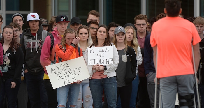 (Al Hartmann  |  The Salt Lake Tribune) 	
About 80 students at Westlake High School in Saratoga Springs left class and stood together in silence at the front entrance of the school Wednesday March 14, 2018 to remember the 17 students who died in a school shooting in Florida.  They held posters of the names of those killed. 