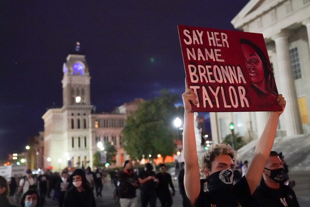(John Minchillo | AP photo)
Protesters march, Thursday, Sept. 24, 2020, in Louisville, Ky. Authorities pleaded for calm while activists vowed to fight on Thursday in Kentucky's largest city, where a gunman wounded two police officers during anguished protests following the decision not to charge officers for killing Breonna Taylor.