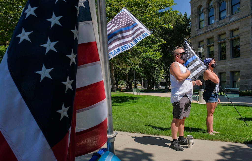 (Leah Hogsten | The Salt Lake Tribune) Supporters of law enforcement gather at Back the Blue rally, Saturday, August 15, 2020 at Washington Square. On July 9, 2021, Garfield County prosecutors charged a 19-year-old from California with an anti-police hate crime after Deputy Cree Carter saw the woman “stomping on a ‘Back the Blue’ sign next to where [a] traffic stop was conducted, crumble it up in a destructive manner and throw it into a trash can all while smirking in an intimidating manner towards [him].”