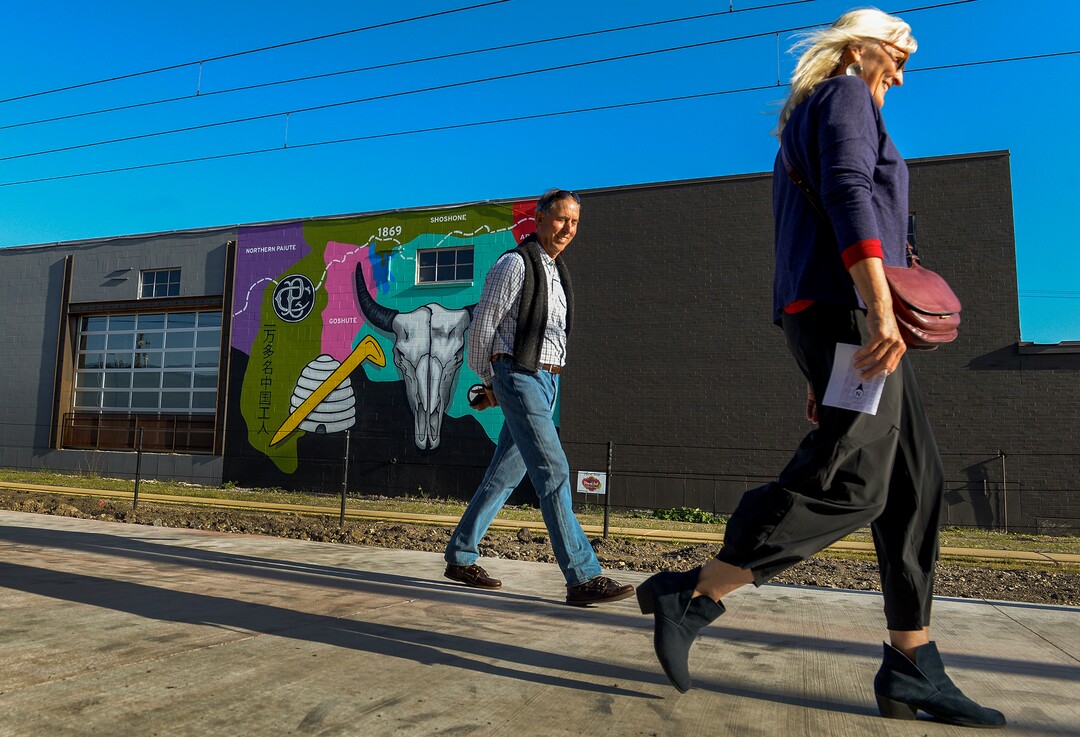 (Leah Hogsten | The Salt Lake Tribune) Tim Wood and his wife Star walked past Trent Call's mural located on the wall of Beehive Distilling during the 2nd annual Mural Fest sponsored by South Salt Lake Arts Council and Utah Arts Alliance. Ten murals were created in South Salt Lake's community between 2100 and 2400 South off of West Temple, May 11, 2019.