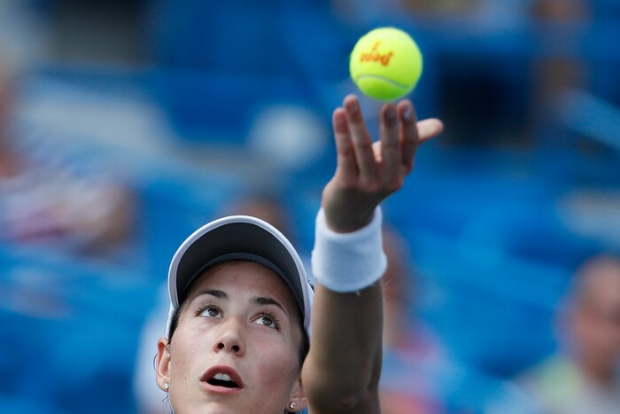 Garbine Muguruza, of Spain, serves to Svetlana Kuznetsova, of Russia, at the Western & Southern Open tennis tournament, Friday, Aug. 18, 2017, in Mason, Ohio. (AP Photo/John Minchillo)