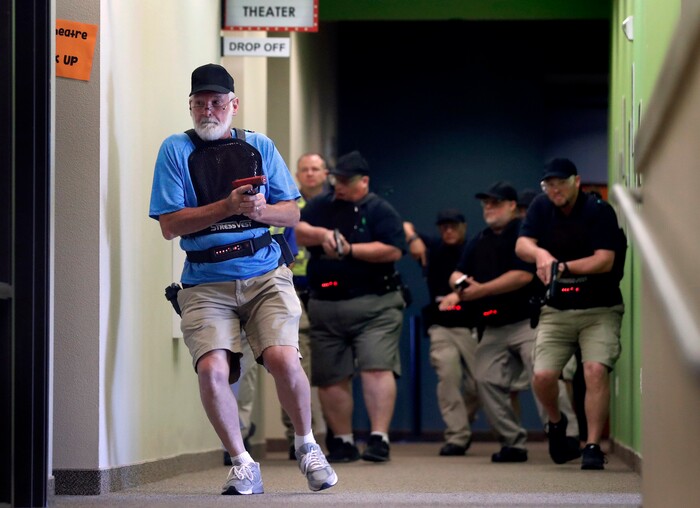 (Tony Gutierrez | AP Photo) In this July 21, 2019 photo, Stephen Hatherley, left, leads fellow trainees down a hallway as they participate in a simulated gun fight scenario at Fellowship of the Parks campus in Haslet, Texas.  While recent mass shootings occurred at a retail store in El Paso, Texas, and a downtown entertainment district in Dayton, Ohio, they were still felt in houses of worship, which haven’t been immune to such attacks. And some churches have started protecting themselves with guns.