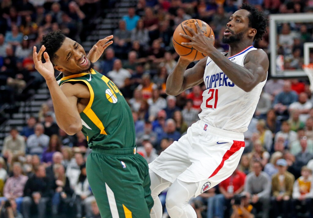 Utah Jazz guard Donovan Mitchell (45) and Los Angeles Clippers guard Patrick Beverley (21) collide in the first half during an NBA basketball game Wednesday, Feb. 27, 2019, in Salt Lake City. (AP Photo/Rick Bowmer)