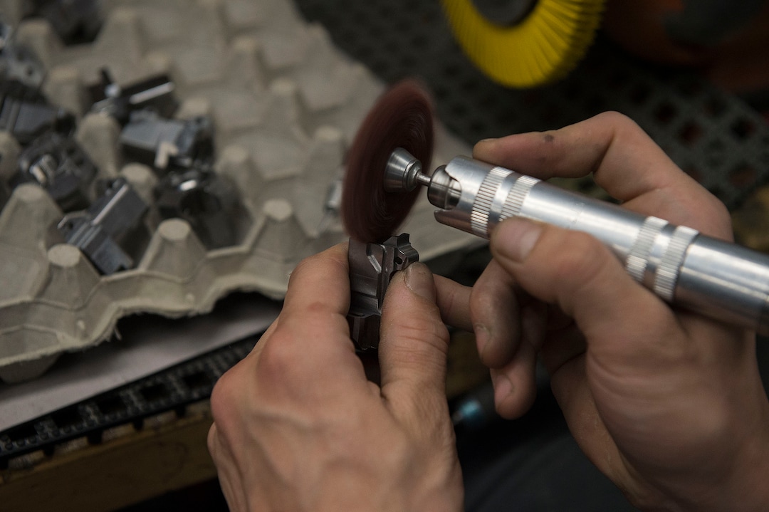 Leah Hogsten  |  The Salt Lake TribuneSilencerco's Robert Brouillette deburrs gun parts in the manufacturing facility. Silencerco is one of the country's largest manufacturers of silencer for guns of all kinds, Friday, May 28, 2017.