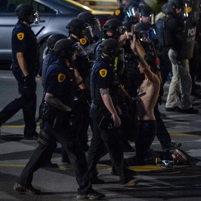 (Trent Nelson  |  The Salt Lake Tribune) Police apprach a protesters marching after curfew in Salt Lake City on Monday, June 1, 2020.
