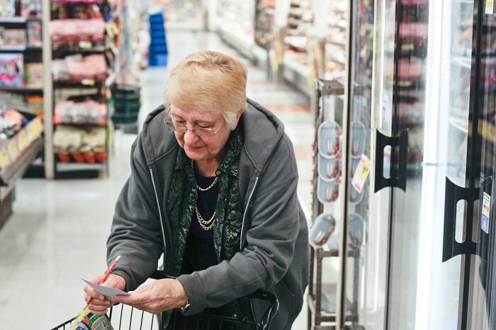 This photo taken Jan. 5, 2018, shows Felicity Varkevisser checking the grocery list for Marian Christensen during her trip to the grocery store in Provo, Utah. (Evan Cobb/The Daily Herald via AP)
