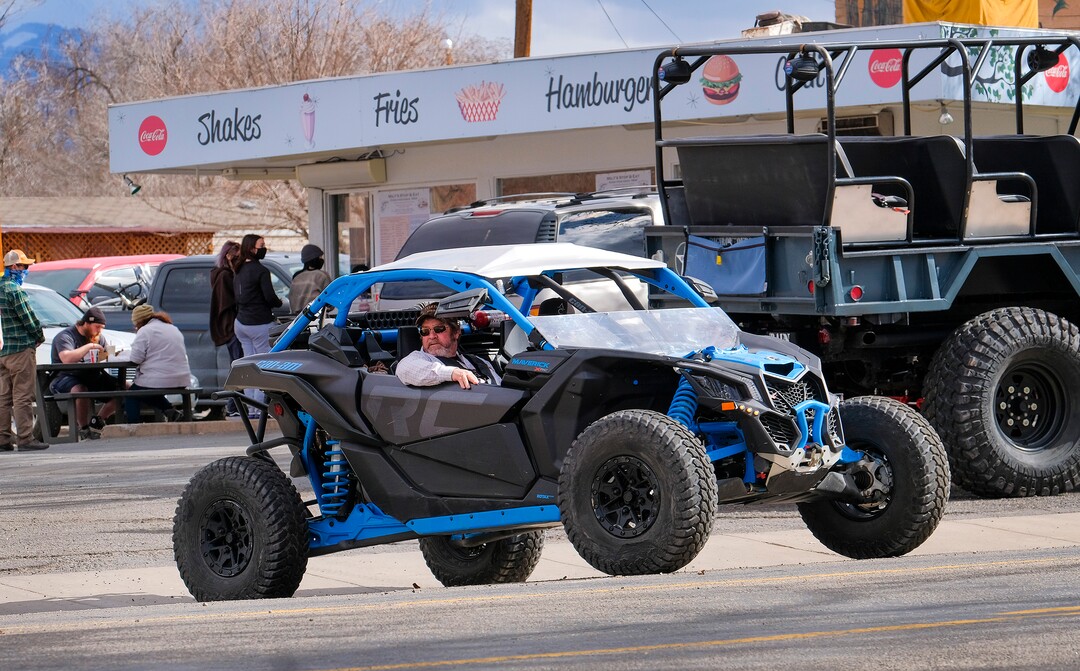 (Leah Hogsten | The Salt Lake Tribune) After stopping at Moab's Milt's Stop & Eat restaurant for lunch, two men in an off-road utility terrain vehicle (UTV) motor back up Mill Creek Drive towards the Sand Flats Recreation Area, Feb. 19, 2021.