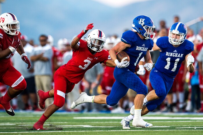 (Chris Detrick  |  The Salt Lake Tribune)  Bingham's Braedon Wissler (1) runs for a touchdown past East's Mekelee Gautavai (3) during the game at Bingham High School Friday, August 25, 2017. Bingham is winning the game 24-17 at halftime. 