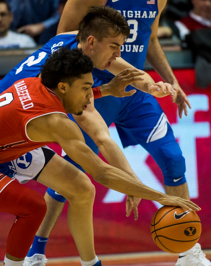 (Rick Egan  |  The Salt Lake Tribune) Brigham Young Cougars guard Zac Seljaas (2) goes for the ball along with Utah Utes guard Sedrick Barefield (0), in basketball action Utah Utes vs. Brigham Young Cougars at the Marriott Center in Provo, Saturday, December 15, 2017.


