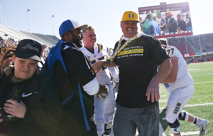(Francisco Kjolseth  |  The Salt Lake Tribune)  Orem head coach Jeremy Hill celebrates with the team after being doused by his players after winning the 4A high school championship game against Dixie at Rice Eccles Stadium in Salt Lake City, Friday, Nov. 16, 2018.

