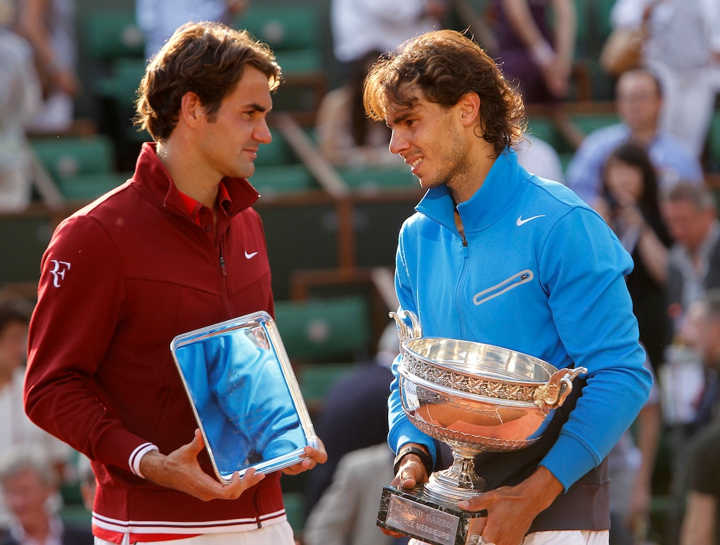 (Lionel Cironneau | AP file photo) Spain's Rafael Nadal, right, and Switzerland's Roger Federer pose with their trophies after the 2011 French Open men's final. Nadal beat Novak Djokovic 6-0, 6-2, 7-5 in the French Open final to win his 20th Grand Slam title, Sunday, Oct. 11, 2020. That ties Roger Federer’s record for most major tennis championships by a man.