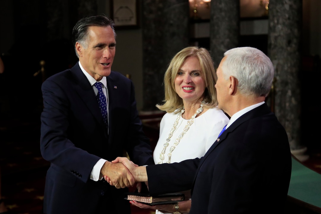 Vice President Mike Pence shakes hands with Sen. Mitt Romney, R-Utah, accompanied by his wife Ann Romney, during a mock swearing-in ceremony Thursday, Jan. 3, 2019, in the Old Senate Chamber on Capitol Hill in Washington. (AP Photo/Manuel Balce Ceneta)