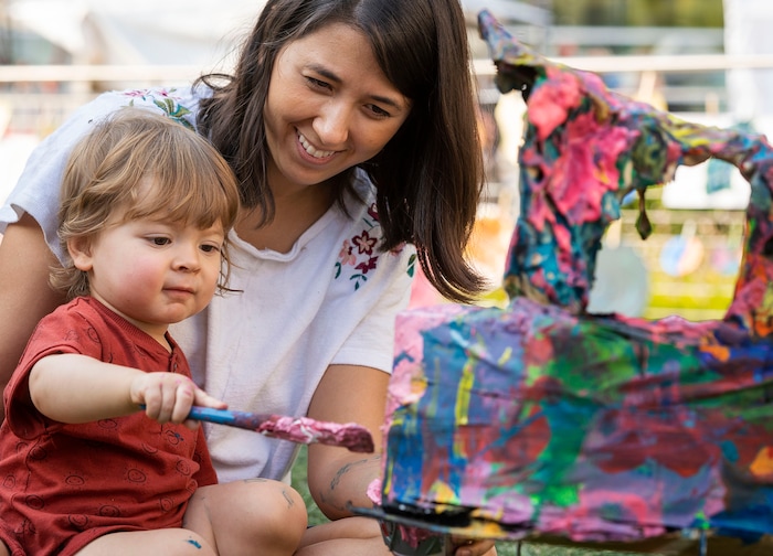 (Rick Egan | The Salt Lake Tribune) Jenny Pinegar assists 16-month-old Jonah as he paints in the creative zone at the Salt Lake Arts Festival, on Saturday, Aug. 28, 2021.