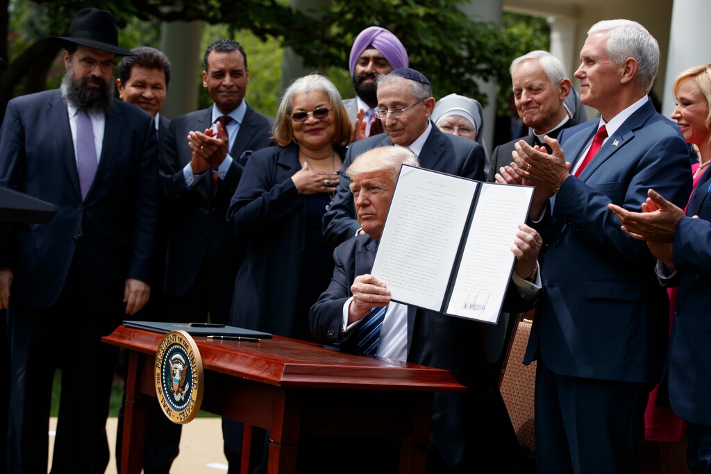 (AP Photo/Evan Vucci)  In this May 4, 2017 file photo, President Donald Trump holds up a signed executive order aimed at easing an IRS rule limiting political activity for churches in the Rose Garden of the White House in Washington.  In an order that undercuts federal protections for LGBT people, Attorney General Jeff Sessions issued a sweeping directive to agencies Friday to do as much as possible to accommodate those who claim their religious freedoms are being violated.  Trump announced plans for the directive last May in a Rose Garden ceremony where he was surrounded by religious leaders. Since then, religious conservatives have anxiously awaited the Justice Department guidance.