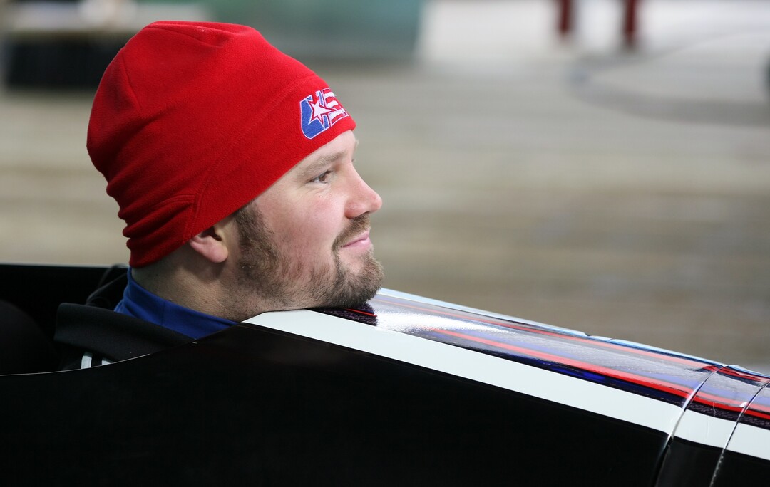 American bobsledder Steven Holcomb, pokes his head out of his sled after a training run for the men's four-man bobsled at the Vancouver 2010 Olympics in Whistler, British Columbia, Tuesday, Feb. 23, 2010. America's best hope for bobsled gold simply does not look like an Olympian.  Barrel-chested and pot-bellied, stretching his racing suit to the absolute limit with 240 pounds packed on his frame, Steven Holcomb has a story all his own. He thought he was going blind two years ago, carries his cell phone even while at the controls of his bobsled and tries to make those around him laugh by breaking into a dance all his own just about everywhere he goes. (AP Photo/Ricardo Mazalan)