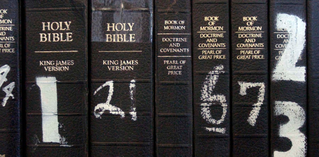 (Leah Hogsten | The Salt Lake Tribune) The Bible and the Book of Mormon sit on a shelf at a Draper facility in April 2004. A parent is challenging whether the Bible is appropriate for school libraries in Davis School District.