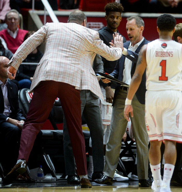 (Steve Griffin  |  The Salt Lake Tribune) University of Utah head coach Larry Krystkowiak high fives assistant coach Tommy Connor after he was ejected from the game during the Utah versus UC Davis men's NIT basketball game at the Huntsman Center in Salt Lake City Wednesday March 14, 2018. 