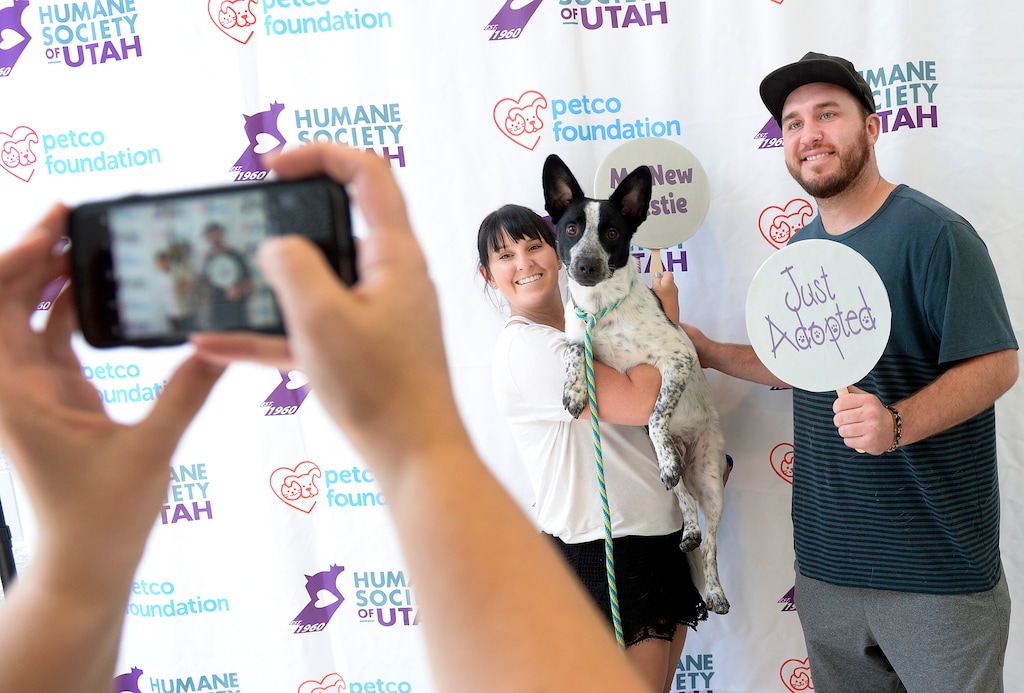 (Leah Hogsten | The Salt Lake Tribune) l-r Marley Colt and boyfriend Jon McFarland are all smiles after adopting Baxter, a 1-year-old heeler mix, during the Humane Society's weeklong adoption event, Clear the Shelters, Saturday, August 19, 2017, a nationwide drive to adopt out cats and dogs.