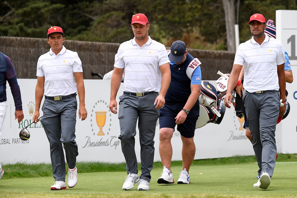 (AP Photo/Andy Brownbill) Tony Finau (right), shown during a Presidents Cup practice round, and partner Bryson DeChambeau lost 2 and 1 in an opening-round match at Royal Melbourne Golf Club.