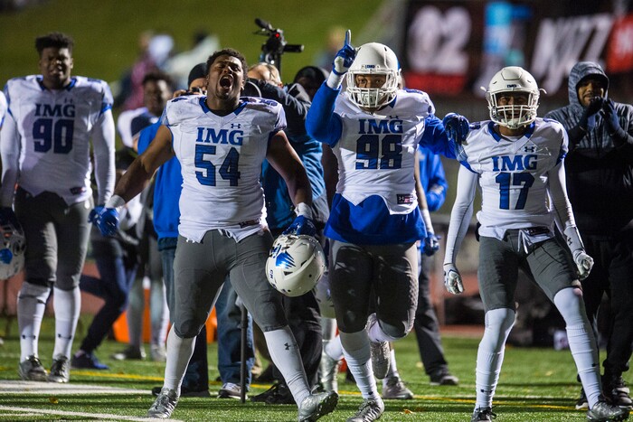 (Chris Detrick  |  The Salt Lake Tribune)  IMG Academy's Taron Vincent (54) IMG Academy's Trevon Riggins (98) and IMG Academy's Lejond Cavazos (17) celebrate a touchdown by IMG Academy's Jermaine Burton (10) during the game at East High School Friday, October 20, 2017. 