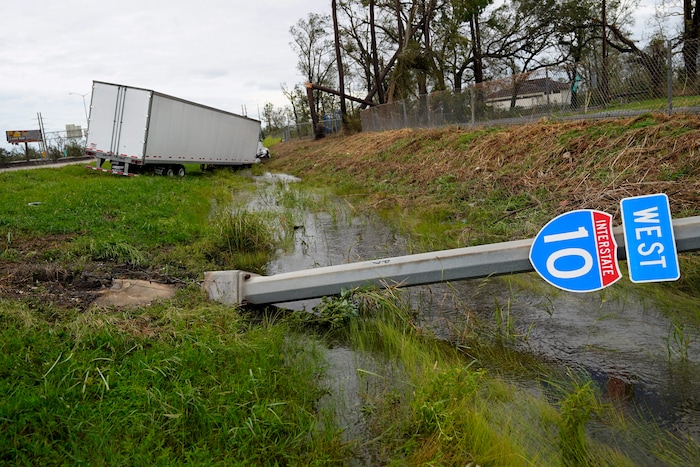 A truck and Interstate 10 sign is seen on Thursday, Aug. 27, 2020, in Lake Charles, La., after Hurricane Laura moved through the state. (AP Photo/Gerald Herbert)