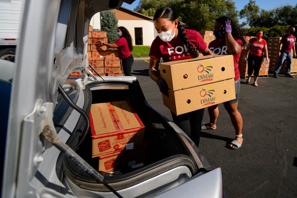 (Trent Nelson  |  The Salt Lake Tribune) Olivia S.halaeua volunteers, handing out food at The Point Church in Kearns on Saturday, Aug. 8, 2020.