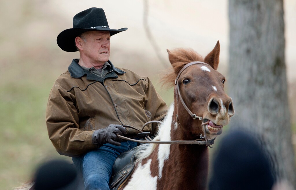 Republican senate nominee Roy Moore rides a horse to a polling station to cast his ballot in Alabama's special Senate election, Tuesday, Dec. 12, 2017, in Gallant, Ala. (Albert Cesare/The Montgomery Advertiser via AP)