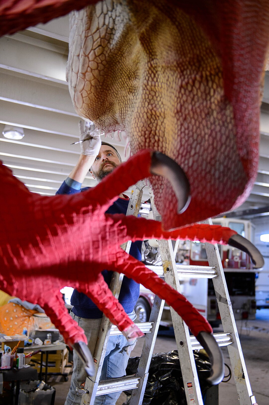 (Trent Nelson | The Salt Lake Tribune)  Artist Stephen Kesler works recently on a giant Red Iguana, to be placed in front of the Salt Lake City restaurant's #2 location. Kesler created the giant whales and other sea creatures for the Living Planet Aquarium. The Red Iguana is 14 feet high and more than 30 feet long.