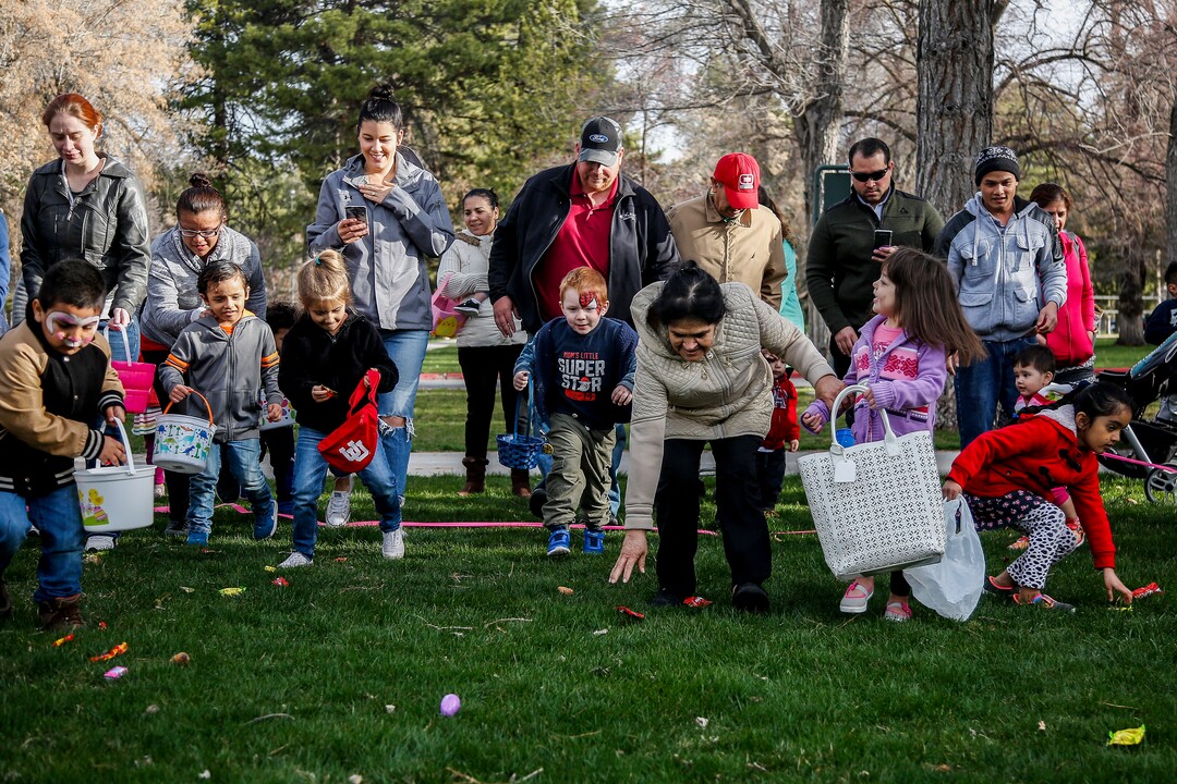 (Nicole Boliaux  |  For The Tribune)  Children and their families run to grab Easter eggs during the annual Easter egg hunt put on by A Kid's Place Dentistry in Liberty Park in Salt Lake City on Saturday, March 31, 2018.