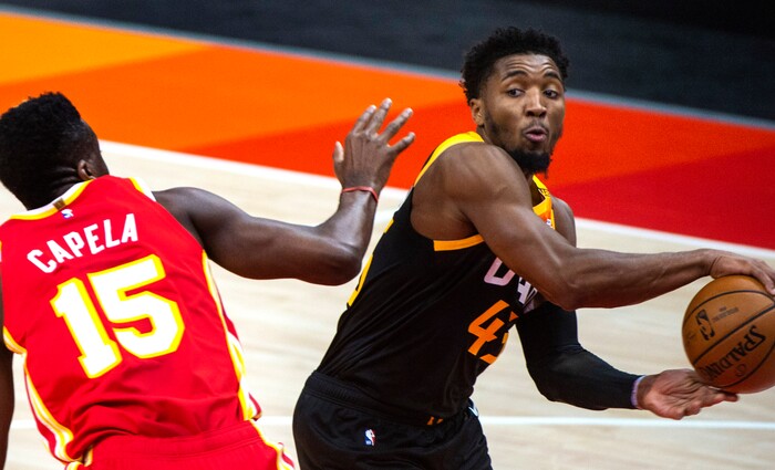 (Rick Egan | The Salt Lake Tribune) Utah Jazz guard Donovan Mitchell (45) makes a pass as Atlanta Hawks center Clint Capela (15) defends, in NBA action between the Utah Jazz and the Atlanta Hawks at Vivint Arena, on Friday, Jan. 15, 2021.,