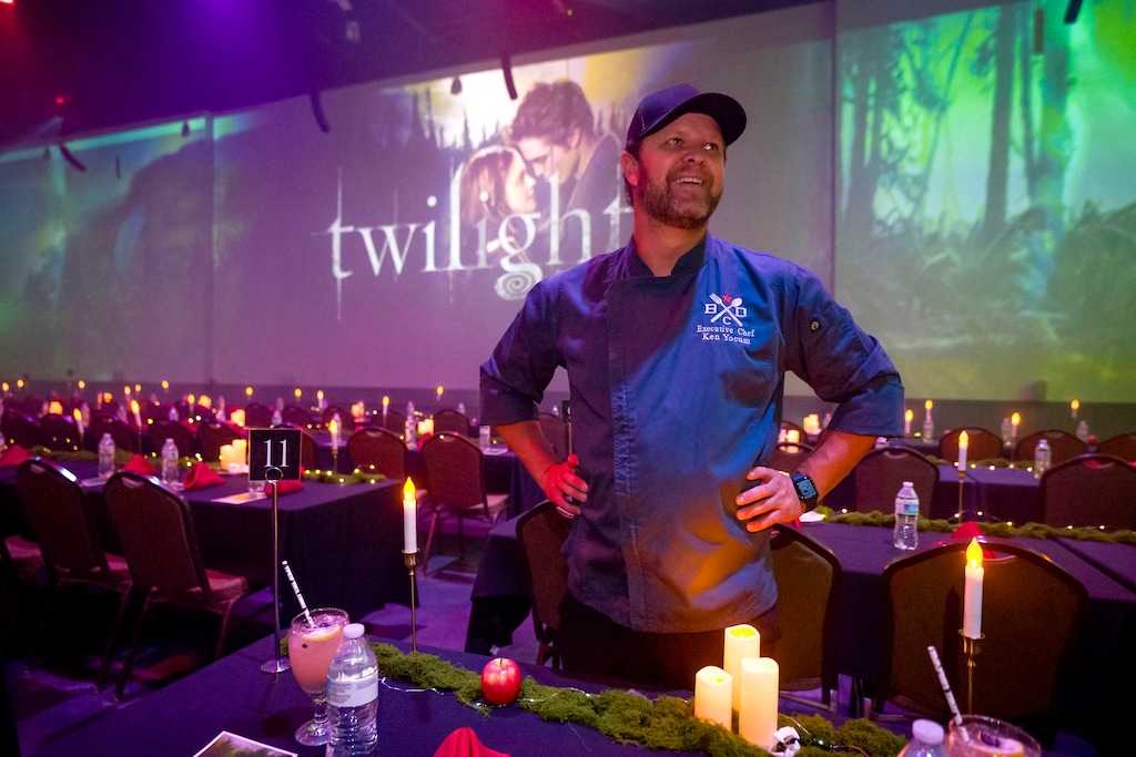 (Bethany Baker | The Salt Lake Tribune) Ken Yocum, owner and founder of CineBites, an event where guests watch a movie and eat food inspired by the movie, speaks before the showing of Twilight at Warehouse 22 in Syracuse on Friday, June 12, 2026.