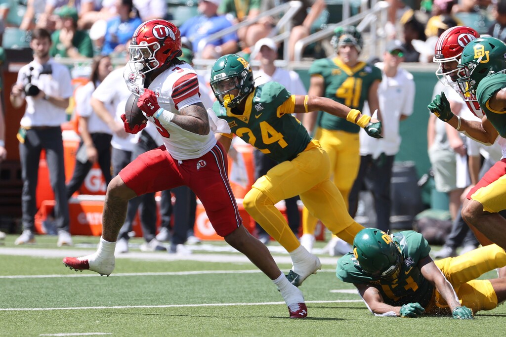Utah running back Ja'Quinden Jackson (3) runs through the Baylor defense in the first half of an NCAA college football game, Saturday, Sept. 9, 2023, in Waco, Texas. (AP Photo/Jerry Larson)
