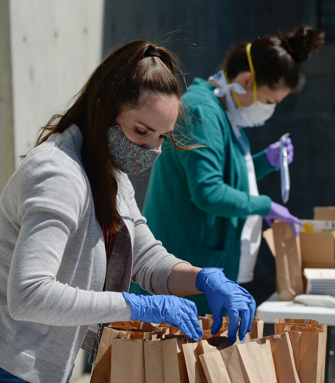 (Francisco Kjolseth  |  The Salt Lake Tribune) The UMFA learning engagement team members Katie Seastrand, left, and Annie Burbidge Ream assemble "UMFA Art Kits," to provide art supplies to high school students to help them complete end-of-year course work. The volunteers filled 1,500 kits with colored pencils, postcards and art activities on Friday, May 4, 2020, to help kids in the Granite School District and Whitehorse High School in San Juan County, to finish school projects and get excited about home projects during the coronavirus pandemic.