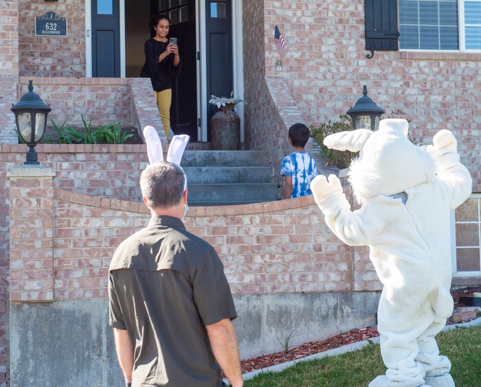 (Rick Egan  |  The Salt Lake Tribune)     Archana Ray snaps a photo of her son Dhruz with the Easter Bunny, on their front porch in Draper. Draper City Parks and Recreation workers along with the police and the fire department, delivered more than 30,000 Easter eggs to children at their doorsteps, Friday, April 10.