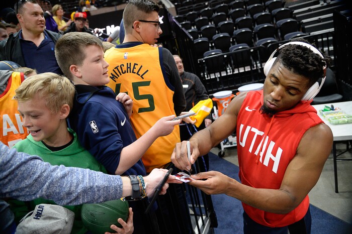 (Francisco Kjolseth  |  The Salt Lake Tribune)  Utah Jazz guard Donovan Mitchell (45) signs autographs for young fans before the Sacramento Kings NBA game at Vivint Smart Home Arena Wed., Nov. 21, 2018, in Salt Lake City.