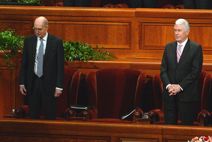 (Al Hartmann  |  The Salt Lake Tribune) 	
President Henry Eyring, first counselor to the First Presidency, left, and President Dieter Uchtdorf, second counselor to the First Presidency, stand for a hymn during the Sunday morning session of the LDS Church’s 187th Semiannual General Conference in Salt Lake City on Oct. 1. Inbetween them is an empty chair, usually occupied by President Thomas S. Monson.  