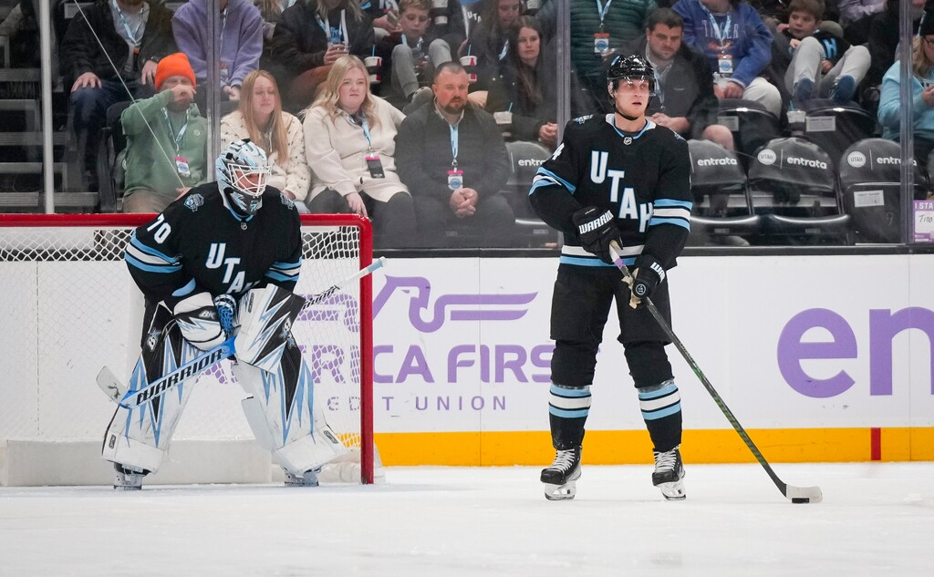 (Bethany Baker | The Salt Lake Tribune) Utah Hockey Club defenseman Juuso Valimaki (4) looks to pass the puck as Utah Hockey Club goaltender Karel Vejmelka (70) defends the goal during the game at the Delta Center in Salt Lake City on Friday, Nov. 29, 2024.